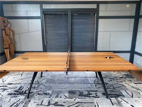 A wooden ping-pong table in a modern living room